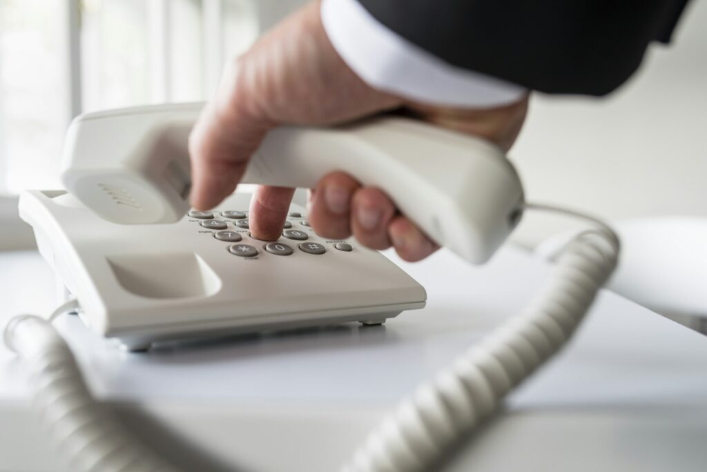 Businessman dialing a telephone number